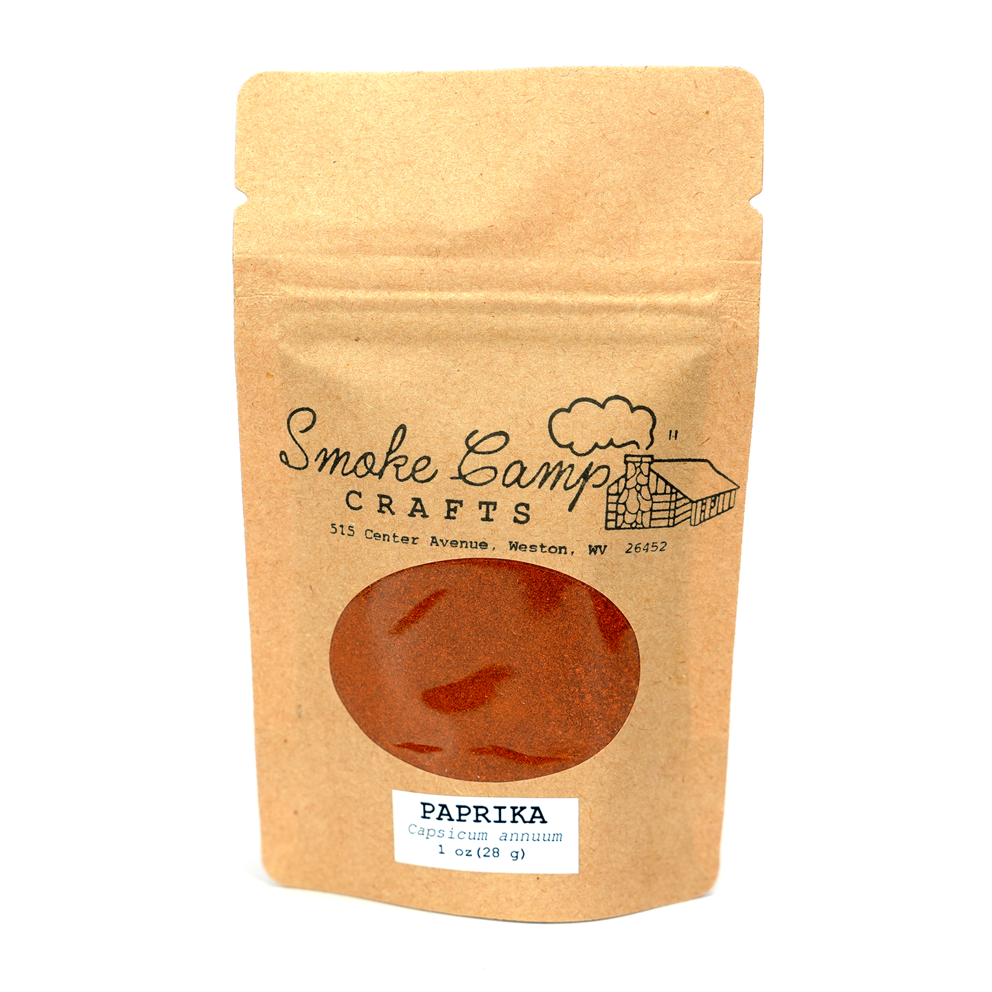 A brown kraft pouch labeled Smoke Camp Crafts displays vibrant Ground Paprika (Capsicum annuum) through a window; label reads “Paprika, ground, 1 oz (28 g).”.