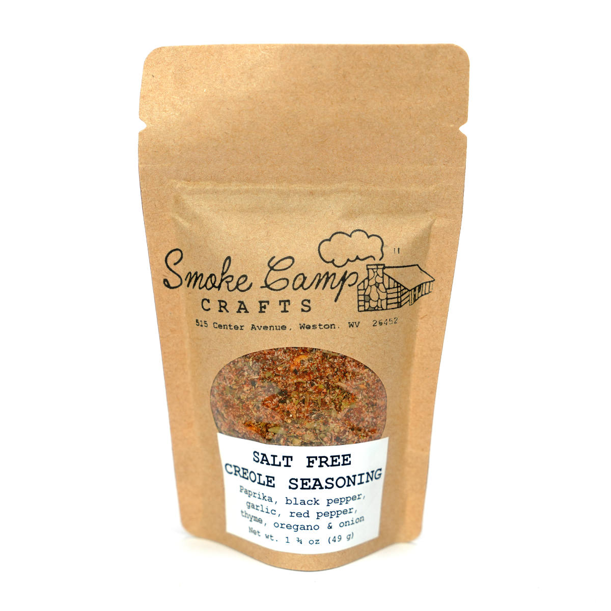 A Smoke Camp Crafts Elderberry Blossom Herbal Tea Blend 3/4 oz pouch, with a clear window showing elderberry blossoms, alfalfa leaf, orange peel, and fennel seed, sits beside a resealable Smoke Camp Crafts Salt Free Creole Seasoning.