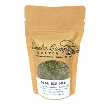 A brown paper pouch labeled “Smoke Camp Crafts Herbal Seasoning Blend - Dill Dip Mix, 1.5 oz” shows green herb mix through a clear window. The label highlights ingredients, serving ideas, and the trusted Smoke Camp Crafts brand.