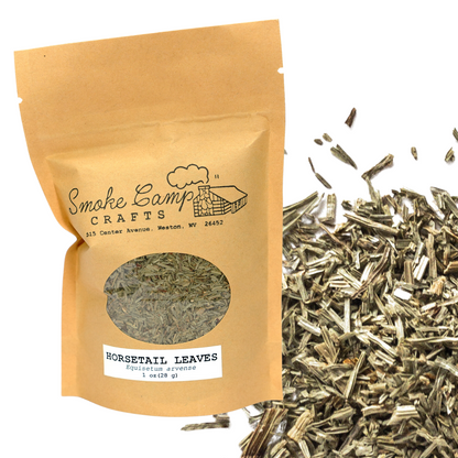 A Smoke Camp Crafts Horsetail Leaves, Dried (1 oz or 4 oz) package sits next to a pile of Equisetum arvense for urinary support. The brown bag features a window displaying the dried leaves inside.